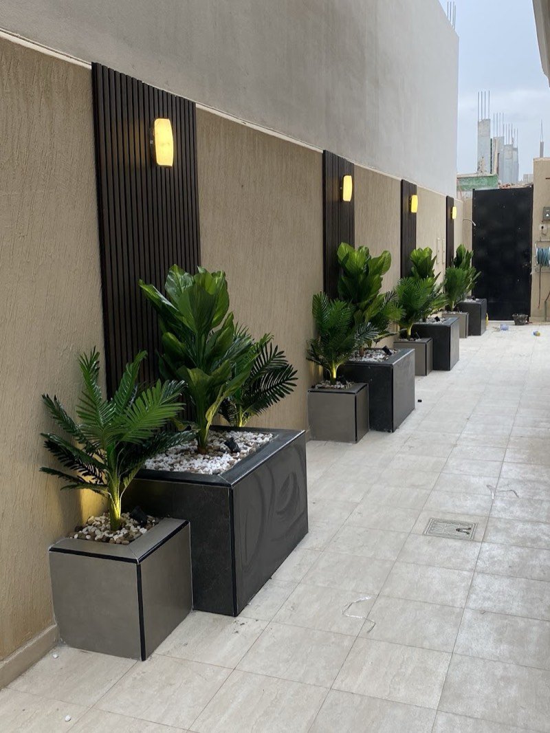 Row of artificial plants in designer planters